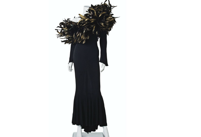A BLACK JERSEY AND FEATHER-EMBELLISHED LONG-SLEEVED GOWN