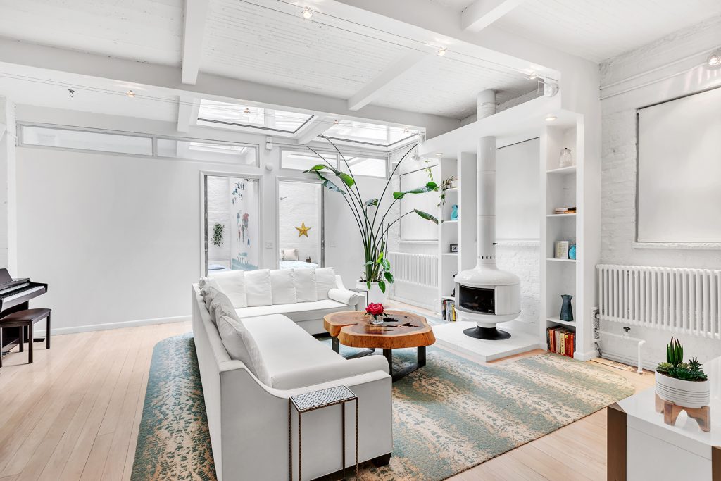 Topped by a 300-square-foot skylight and a rooftop grill, this $3.5M Chelsea triplex is a looker