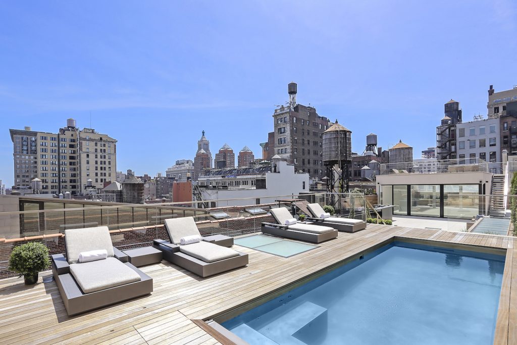 The massive roof deck at this $15.5M Flatiron penthouse has a 20-foot pool and full bar