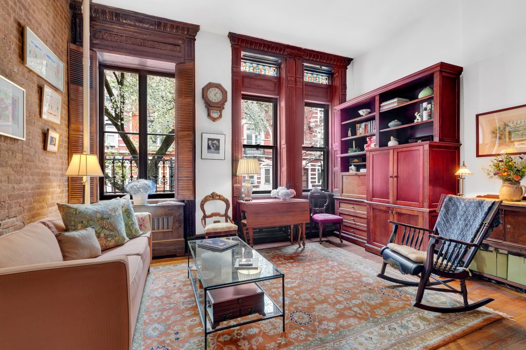 $465K Upper West Side studio has stained-glass windows, wood shutters, and more
